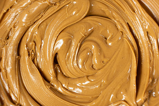istock Creamy Texture American Natural Peanut Butter Top View Macro 2216091231