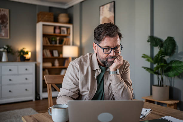 istock Thoughtful mature man working from home office using laptop 2216091841