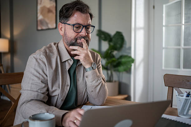 istock Focused mature professional working from home office on laptop 2216091843