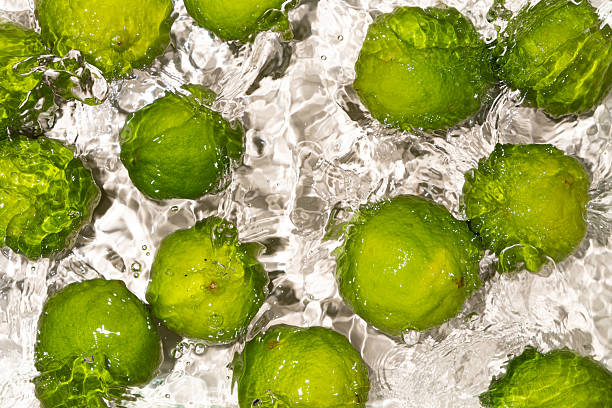 istock Fresh Whole Limes Floating in Water Top View 2216092125
