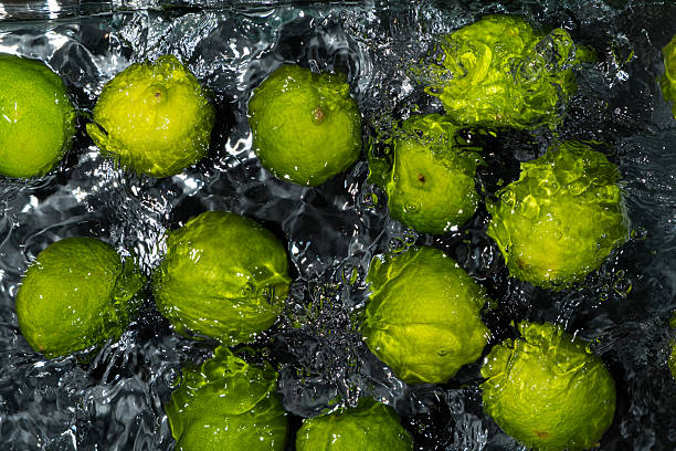istock Whole Limes Drifting in Water with Soft Ripples 2216092141