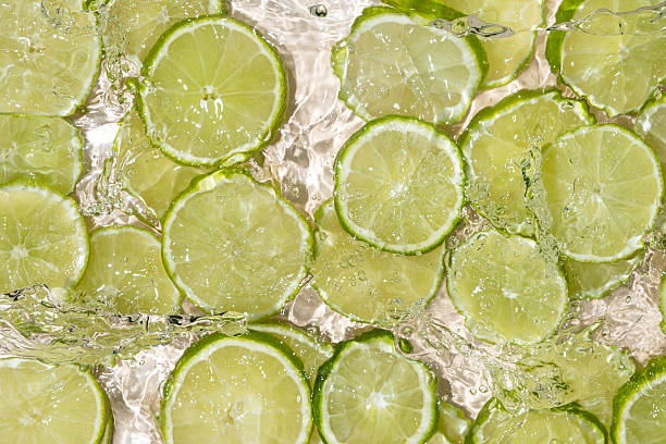 istock Fresh Limes In Motion. Splashing Water Top View 2216092160