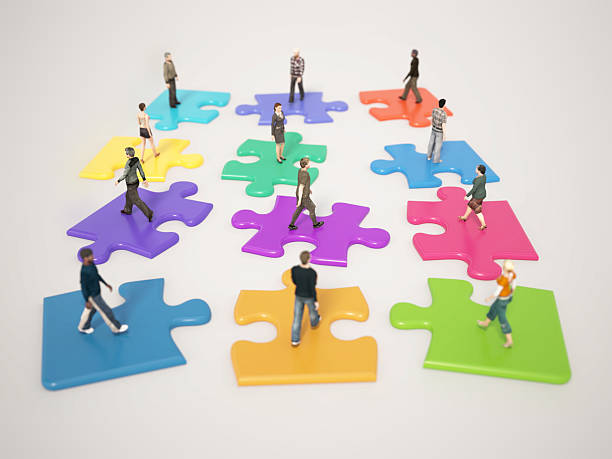 istock People collaborating on colorful puzzle pieces representing teamwork and unity in a creative environment 2216092804