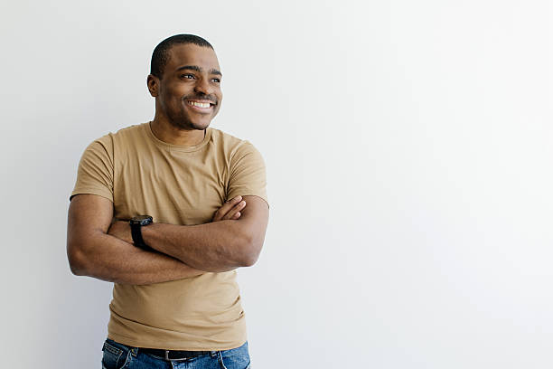 istock Handsome Young Black Man Standing With Folded Arms And Looking Aside 2216093749