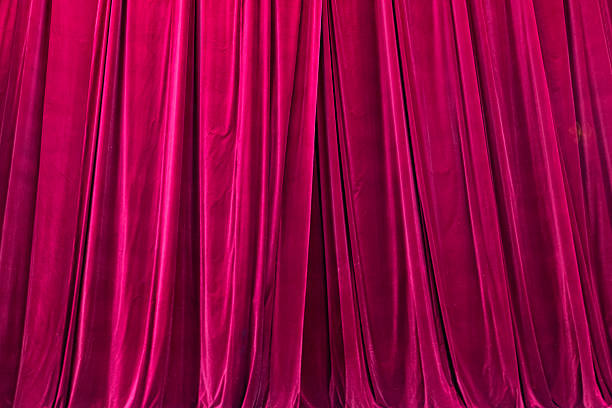 istock Red curtain in theatre background 2216098358
