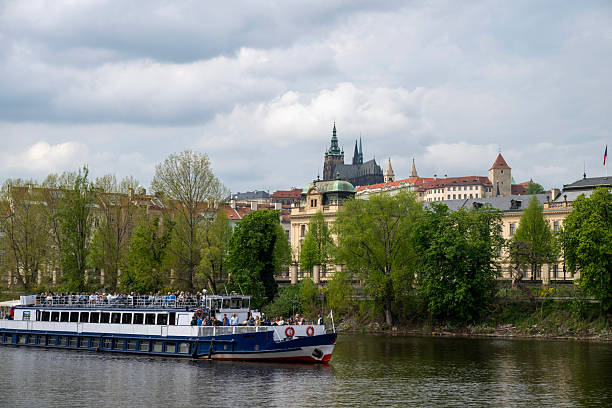 View across river to old town and boat, Prague