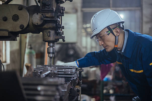istock Asian male engineer working on lathe 2216100840