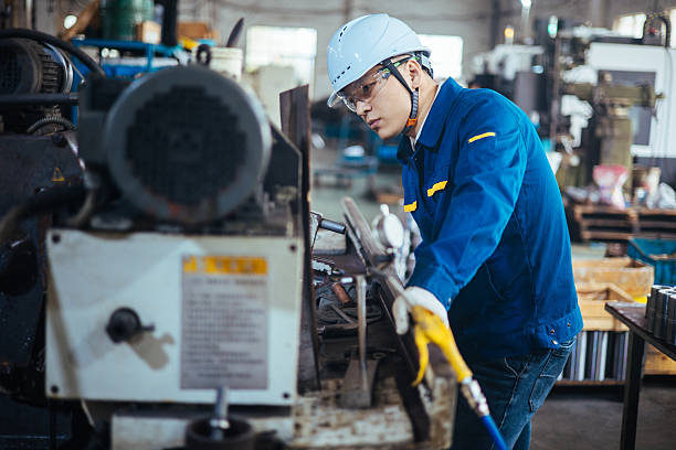 istock Asian male engineer working on lathe 2216100877