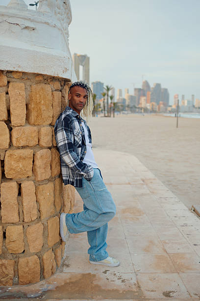istock Young man with blonde dreadlocks posing on the beach 2216100937