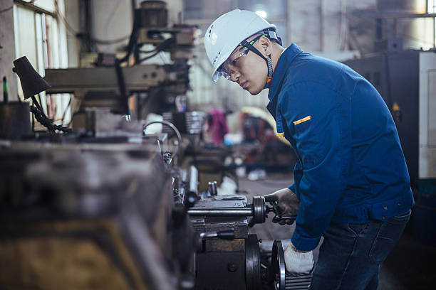 istock Asian male engineer working on lathe 2216100939