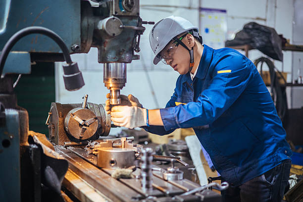 istock Asian male engineer working on lathe 2216101047