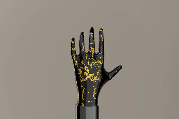 istock A hand with gold paint on it 2216107240