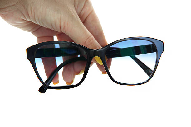 istock Black plastic glasses in hands with gradient lenses isolated on white background 2216107526