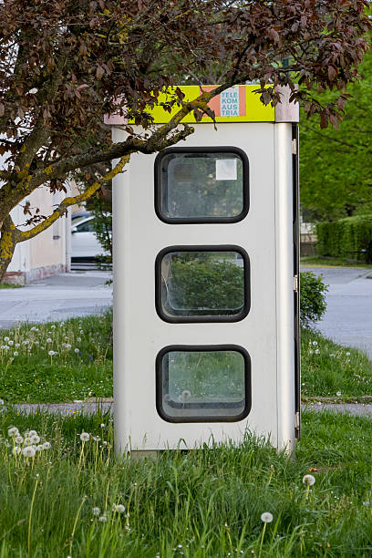istock Old Telephone Booth in Overgrown Grass 2216109221