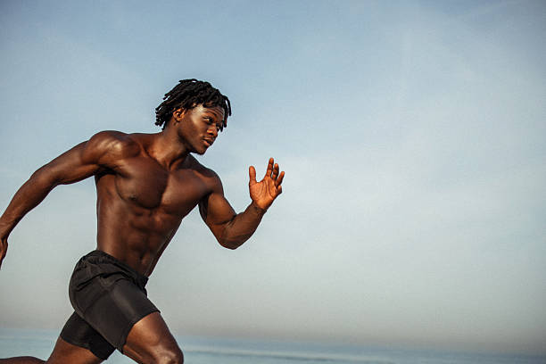 istock Athletic male runner sprinting outdoors under a clear blue sky 2216111325