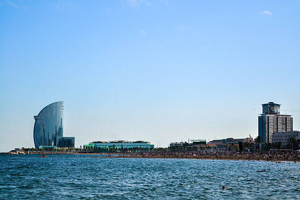 Panoramic view of Barceloneta neighborhood in Barcelona, showing residential buildings near the Mediterranean coastline.