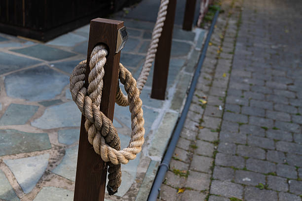 istock Rope wrapped around wooden post near cobblestone pathway 2216116132