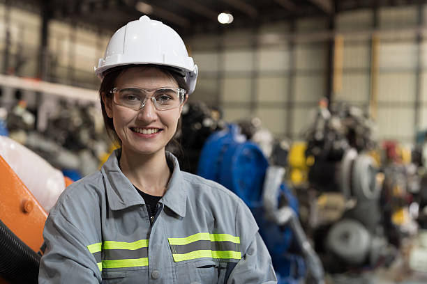 istock Woman engineer and automatic robotic arm in storage warehouse.  Technology robotics arms for manufacturing industry, welding , logistics and palletizing 2216116243