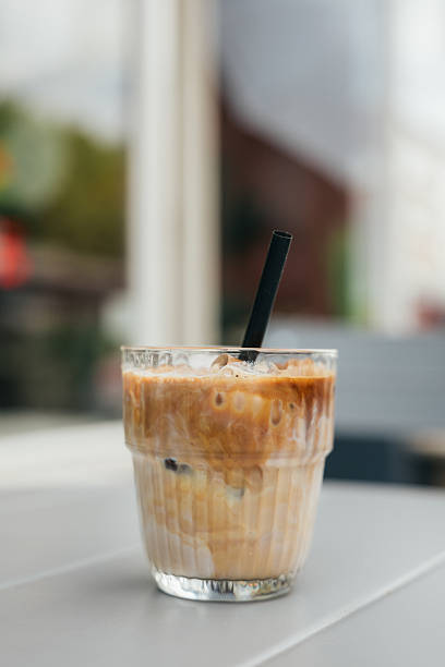 istock Iced coffee sitting on a table outdoors at a cafe 2216116274