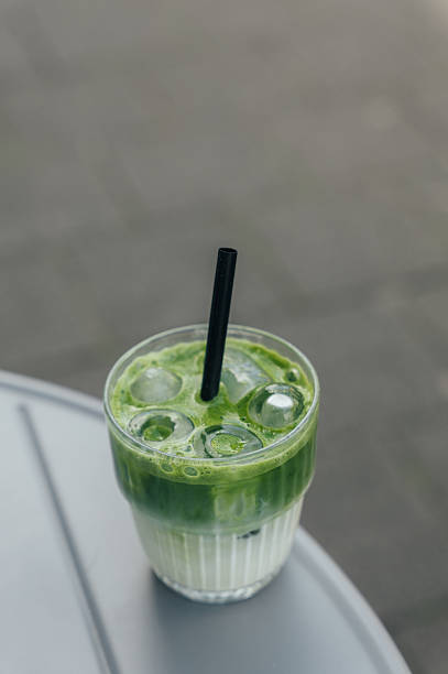 Iced matcha latte resting on a table outdoors