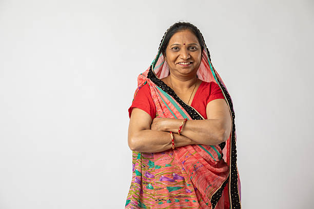 istock Old woman in sari standing on white background 2216116717