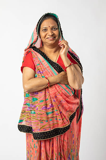istock Old woman in sari standing on white background 2216116742