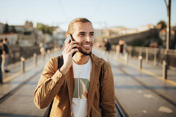 istock Man using a smart phone on the famous Porto bridge. 2216117032