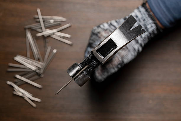 Multifunction shockproof steel hammer with nail in hand, close up, top view. Hand tool for working. Magnetic claw hammer for woodworking, nail suction hammer