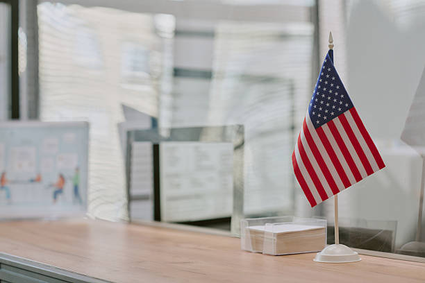 istock American Flag Displayed on Office Desk with Sunlight 2216119996