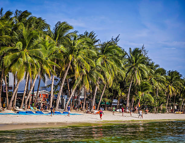 Tropical Boracay island beach in Philippines with algae bloom making emerald green ocean water