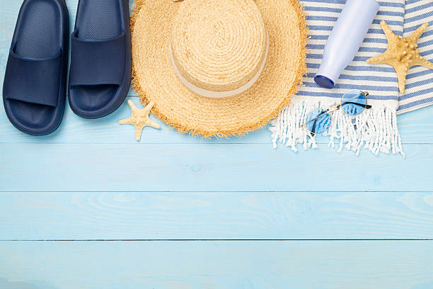istock Blue beach accessories on wooden background, top view. Copy space for text 2216126981
