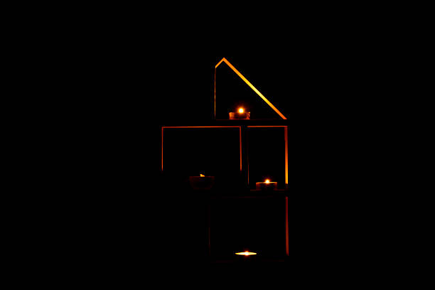 Decorative house with candles in the dark as decor in the apartment