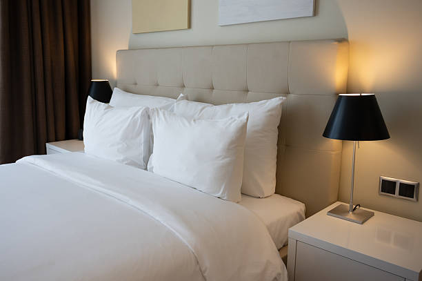 istock Comfortable Hotel Room with King Size Bed and Soft Pillows Inviting Guests for Relaxing Stay 2216128062