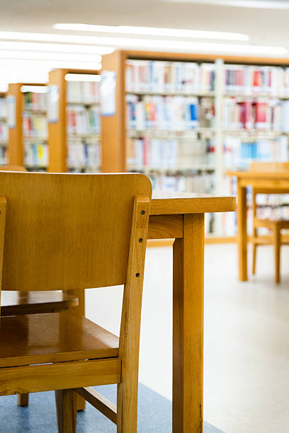 istock Public library with wooden tables and chairs 2216129117