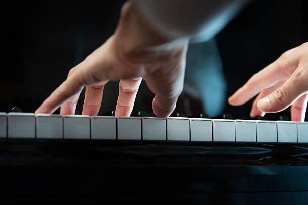 Woman's hands playing the piano