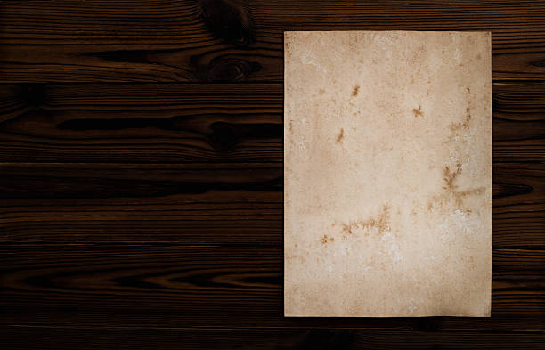 Aged dirty paper on wooden table