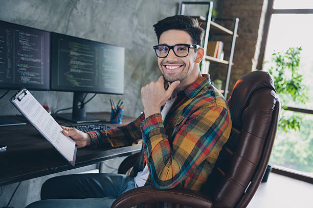 istock Profile photo of smart creative cyber security engineer hand touch chin hold clipboard documents loft interior business center indoors 2216131242