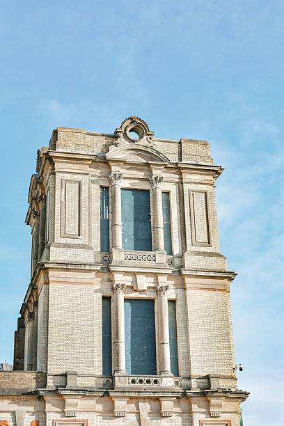A classic architectural building with ornate details against a clear blue sky.