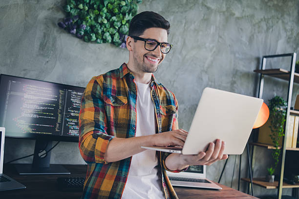 istock Portrait of smart skilled c++ developer hold use wireless laptop write email coworking loft office inside 2216135826