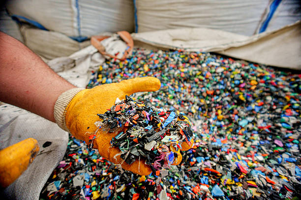 istock Worker Holding Recycled Plastic Pellets in Hands with Protective Gloves 2216136696
