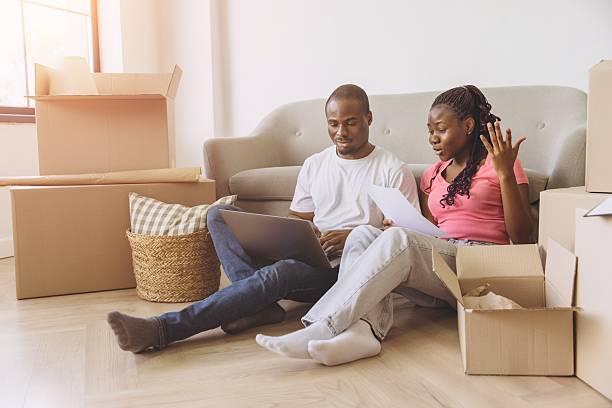istock Young african american couple organizing their move with laptop and documents 2216136780