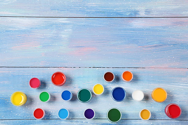 istock Colorful gouache paints on blue wooden table 2216141243