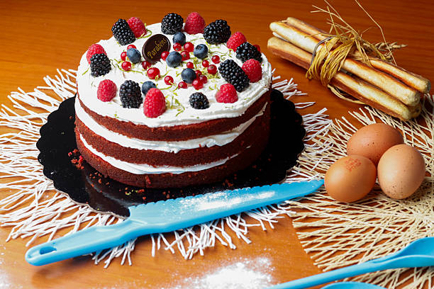 istock Whipped Cream Berry Cake on Wooden Table with Baking Utensils 2216141285