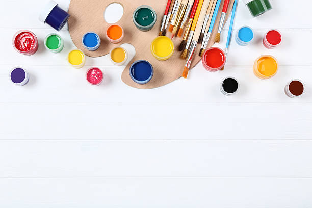 istock Colorful gouache paints and brushes on white wooden table 2216141454