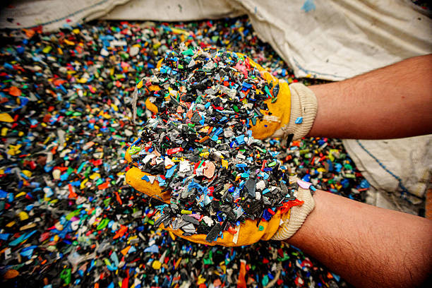 istock Worker Holding Recycled Plastic Pellets in Hands with Protective Gloves 2216142206