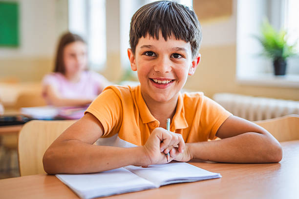 istock happy school boy pupil sit in school class in the classroom 2216145540