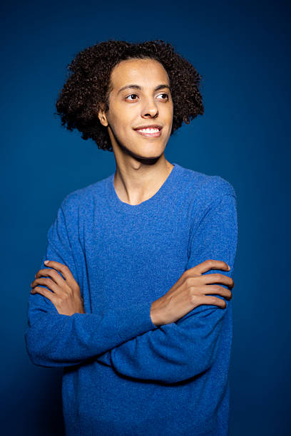 istock Middle Eastern man smiling with arms crossed against a blue background 2216146430
