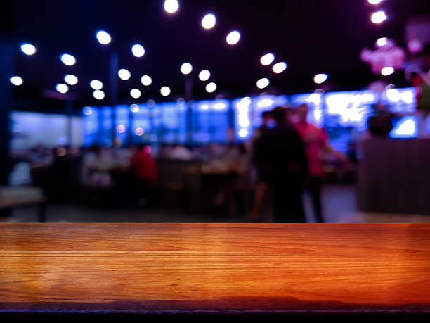 istock Empty wooden table in front with dark tone blurred background. 2216146947