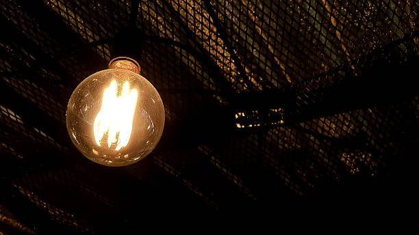 istock Vintage style decorative orange light lamp on dark background. 2216146955