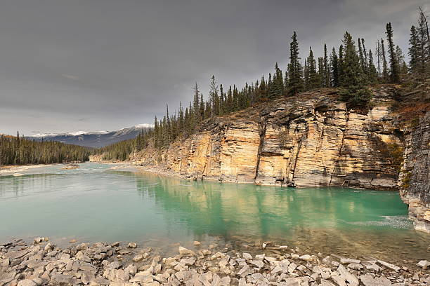 istock The Athabasca River running downstream the Athabasca Falls-carved gorge, the Maligne Range snowy peaks in background. Jasper NP-Alberta-Canada-271 2216147451